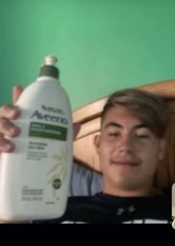 Person with Aveeno bottle